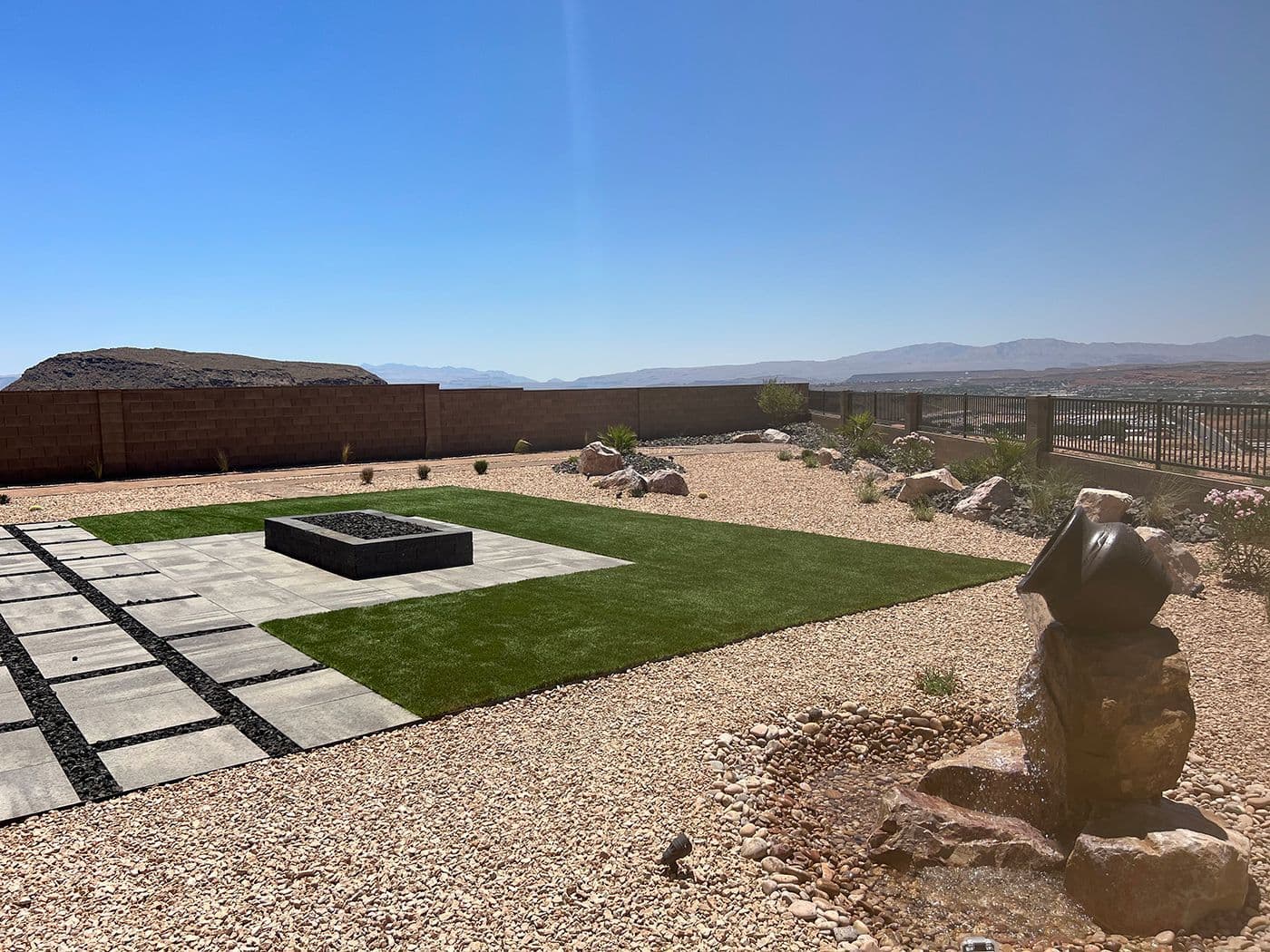 Lush backyard landscaping with manicured plants and stone features