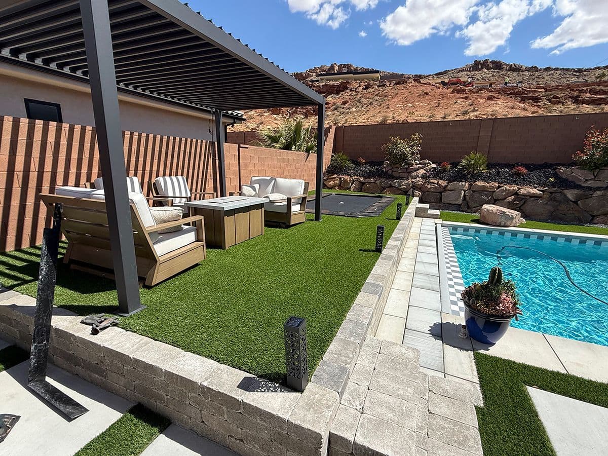 Elegant patio with chairs overlooking a custom pool